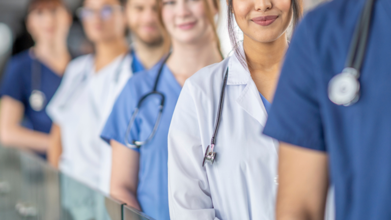 an out of focus image of medical professionals lined up with soft smiles